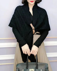Its sculptural knit pattern contrasts naturally against smooth wardrobe pieces, while the shoulder drape creates an easy, enveloping silhouette.