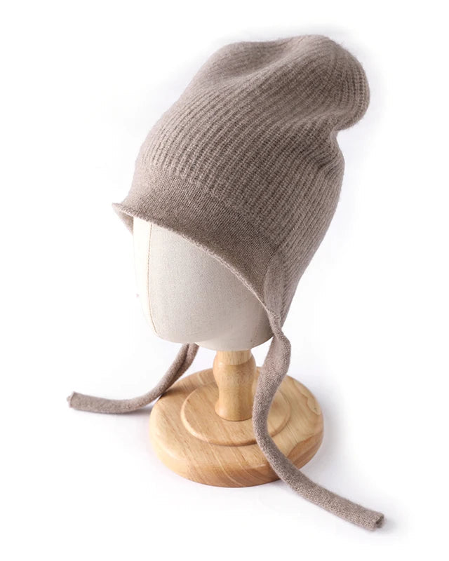 100% merino wool striped drawstring pullover ski ear-flap hat. Soft, warm, and micro-elastic — a cosy women’s winter knitted skull cap.