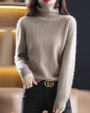 Plush mink cashmere turtleneck sweater for women with tall ribbed collar, fuzzy knit texture, long sleeves and ribbed cuffs, a relaxed fall-winter 100% mink cashmere pullover.