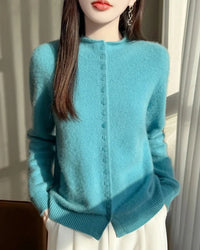 A 100% Australian merino wool mock neck cardigan with a button front and regular fit, designed for poised warmth that layers easily from commute to dinner.