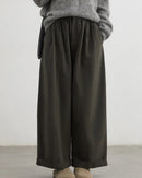 A pair of high-waist wide-leg casual trousers featuring front pleats, a zipper fly, and a relaxed fit for a comfortable, elongated silhouette.