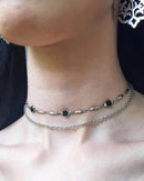 A gothic double-layer necklace featuring black crystal-set circles on a zinc alloy chain, designed for a bold, punk-inspired alternative look.