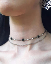 A gothic double-layer necklace featuring black crystal-set circles on a zinc alloy chain, designed for a bold, punk-inspired alternative look.