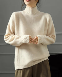 A softly raised neckline offers gentle coverage, while the raglan sleeves create a natural shoulder line and relaxed movement.