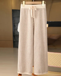 A pair of merino wool striped wide-leg trousers featuring a seamless knit, a mid-rise waist, and a fluid silhouette for elegant, warm comfort.