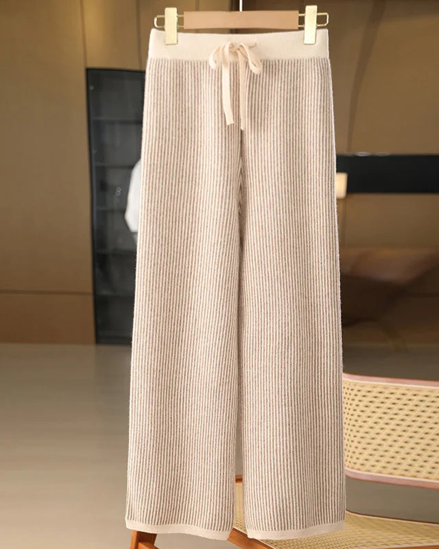 A pair of merino wool striped wide-leg trousers featuring a seamless knit, a mid-rise waist, and a fluid silhouette for elegant, warm comfort.