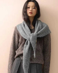 Defined by a triangular shape and tactile knit texture, this scarf offers an effortless approach to layered dressing.