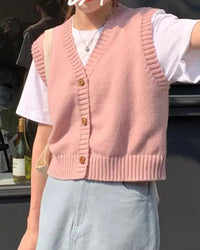 Its button-front V-neck detail adds a structured focal point to the otherwise relaxed silhouette.