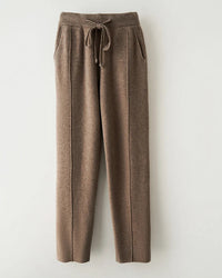 A merino wool tapered knit pants with high elastic waist, tapered legs, ankle length and slight stretch, designed for a cozy winter layering look that pairs from sneakers to boots.