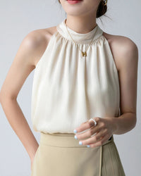 Slim-fit halter camisole top. Lightweight woven fabric, single-button closure.