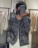A pure cashmere open cardigan featuring a classic houndstooth pattern, a relaxed silhouette, and a tassel fringe hem for sophisticated, layered warmth.