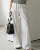 Women's elastic-waist wide-leg pants made from breathable cotton blend fabric, featuring side pockets and a relaxed silhouette for spring and summer comfort.
