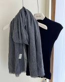 A lightweight cotton scarf shawl with a pleated waffle texture and long cut, designed for soft volume and versatile layering in any season.