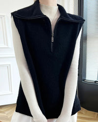 A half-zip merino wool vest with wide fold-down collar, half-zip front, ribbed armholes, sleeveless, regular fit, designed for a cozy winter layering look that pairs from sneakers to boots.