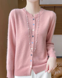 A merino wool button-front cardigan with O-neckline, button details and soft seamless knit, designed for a cool-weather layering look that pairs from sneakers to boots.