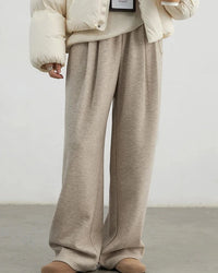 Plush high-waisted wide-leg trousers with front pleats and an elastic waist, designed for opaque warmth that layers easily from office to evening.