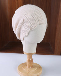 Scalloped pointelle wool beanie with leaf-pattern openwork, softly shaped scalloped edge and textured knit crown, a delicate solid fall-winter wool hat for commuting or walks.