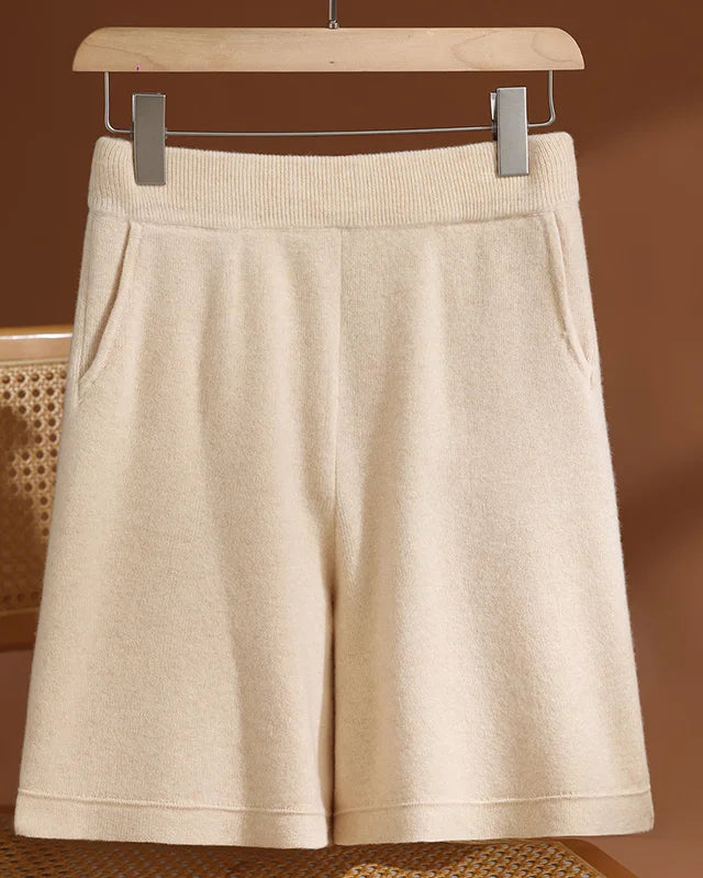 A pair of high-waist knit shorts crafted from extrafine merino wool, featuring a seamless construction and practical side pockets for effortless style.