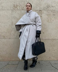 Clean lines meet enveloping volume in a padded coat shaped by a statement shawl and an adjustable waist.