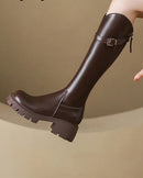 A pair of knee-high riding boots featuring a sleek PU upper, a sturdy platform square heel, and a classic buckle accent for a timeless and elegant look.