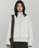 A reversible polyester jacket with a stand collar, zip front and cotton grid-pattern surface, designed for polished versatility that layers from commute to weekend.