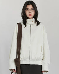 A reversible polyester jacket with a stand collar, zip front and cotton grid-pattern surface, designed for polished versatility that layers from commute to weekend.