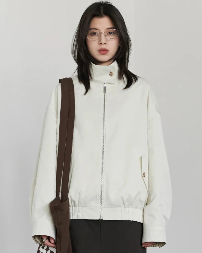 A reversible polyester jacket with a stand collar, zip front and cotton grid-pattern surface, designed for polished versatility that layers from commute to weekend.