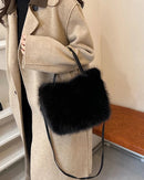 A soft faux fur bucket tote with a casual shape, polyester lining and shoulder or crossbody carry, designed for a roomy everyday look that moves from day to evening.