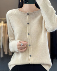 A pure wool O-neck cardigan with a button-front closure and ribbed trim, designed for a soft, classic look suitable for layering.