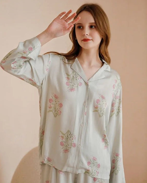 Light Green viscose satin pajama set featuring a delicate pink floral print. This two-piece set includes a long-sleeved, button-down shirt with a classic turn-down collar and matching full-length trousers.