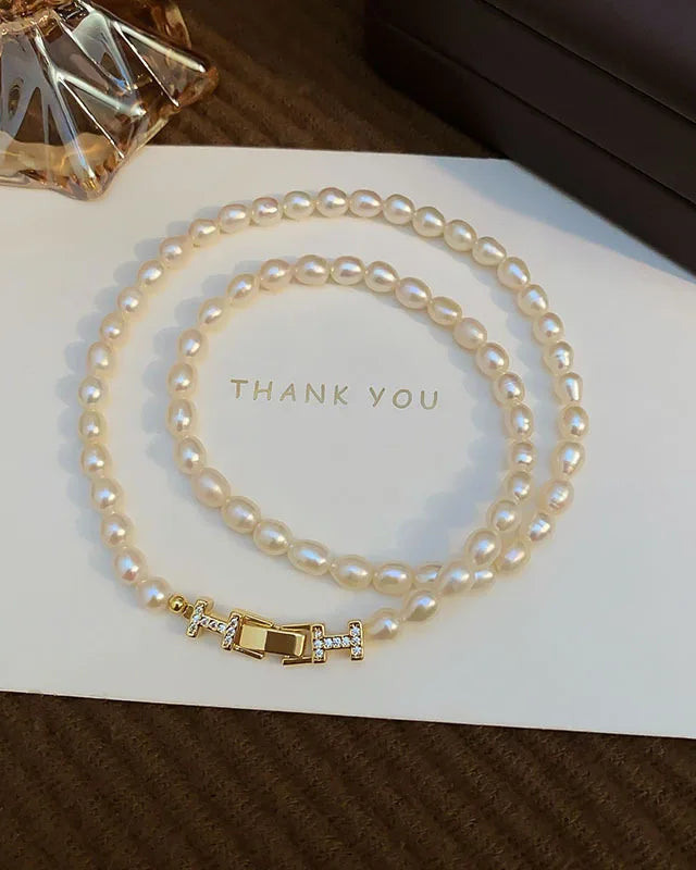 A party necklace featuring certified freshwater pearls with crystal accents on a no-fade 14K gold-filled chain, designed for an elegant, versatile look.