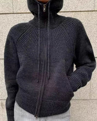 A cashmere hooded zip-up cardigan with hooded neckline, zip closure, thick knit and loose fit, designed for a cozy winter layering look that pairs from sneakers to boots.
