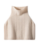 A wool and cashmere turtleneck poncho with a thick ribbed knit, designed for a short silhouette that layers easily over coats and dresses.