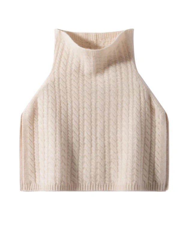 A wool and cashmere turtleneck poncho with a thick ribbed knit, designed for a short silhouette that layers easily over coats and dresses.