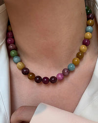 A beaded necklace featuring certified natural tourmaline beads on a 14K gold-filled chain, designed for a relaxed, bohemian look with a lobster clasp.