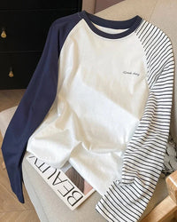 A striped cotton-blend raglan top with a round neckline and full sleeves, designed for a casual everyday look that layers from spring to autumn.