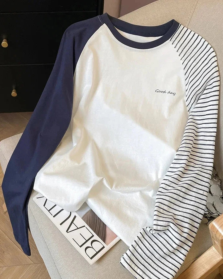 A striped cotton-blend raglan top with a round neckline and full sleeves, designed for a casual everyday look that layers from spring to autumn.