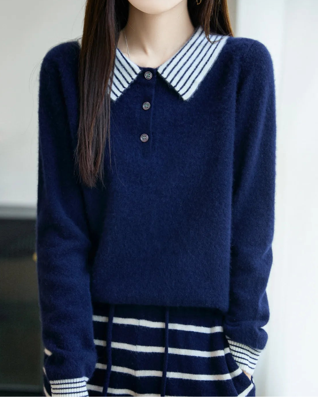A striped-collar wool polo sweater with striped polo collar, button placket, striped cuffs, loose fit, long sleeves and stretch, designed for a cozy winter layering look that pairs from sneakers to boots.