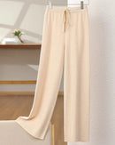 Extrafine Merino wool wide-leg trousers — high waist, lace-up detail, naturally warm knit. A refined autumn-winter essential.