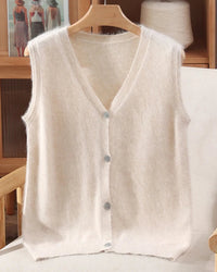 A mink cashmere v-neck vest with v-neck, button front, sleeveless, regular fit and slight stretch, designed for a cozy winter layering look that pairs from sneakers to boots.