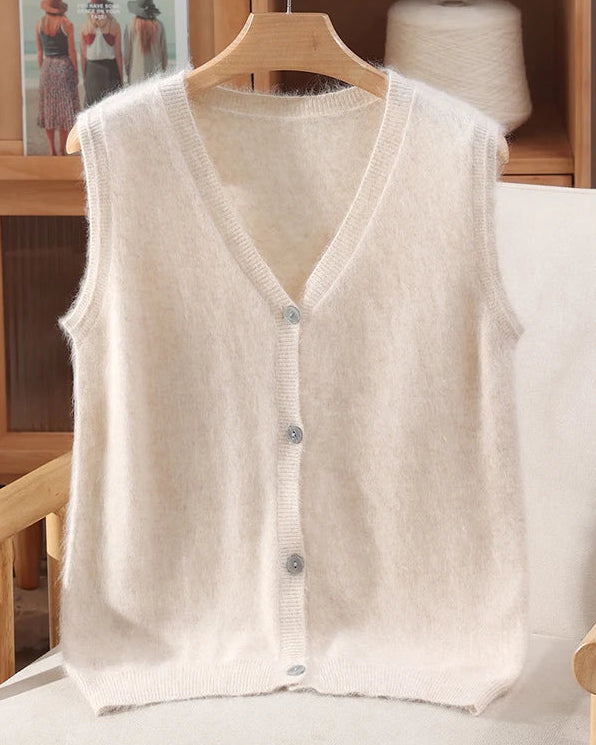 A mink cashmere v-neck vest with v-neck, button front, sleeveless, regular fit and slight stretch, designed for a cozy winter layering look that pairs from sneakers to boots.