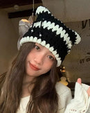 Striped crochet cat-ear beanie with contrasting stripes, pointed cat-ear corners, openwork stitches and metal accents, a playful cotton-blend streetwear hat for everyday wear.