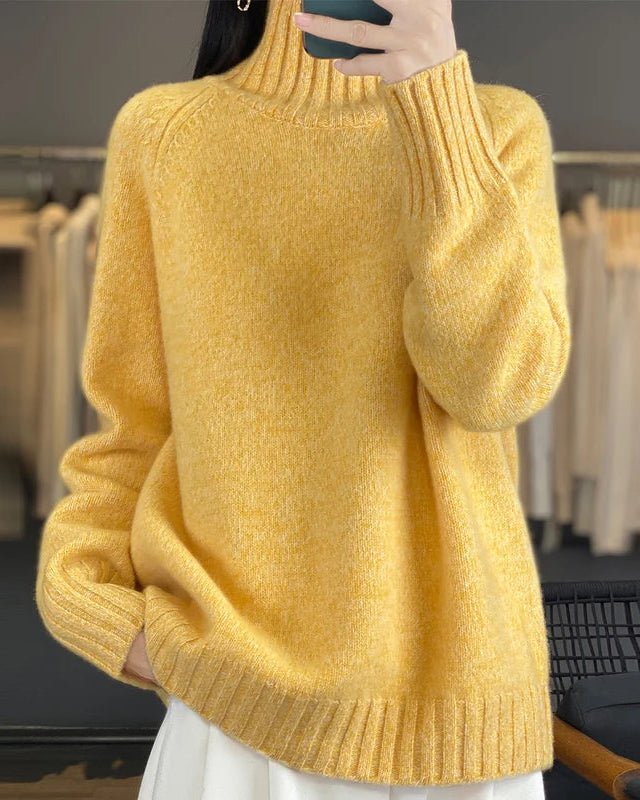 A thick merino wool turtleneck sweater with a loose fit and raglan sleeves, designed for soft, anti-pilling warmth that layers easily over shirts.