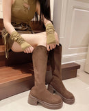 A pair of knee-high boots featuring a sleek stretch flock upper and a sturdy platform square heel, designed with a back zipper for a modern and comfortable fit.