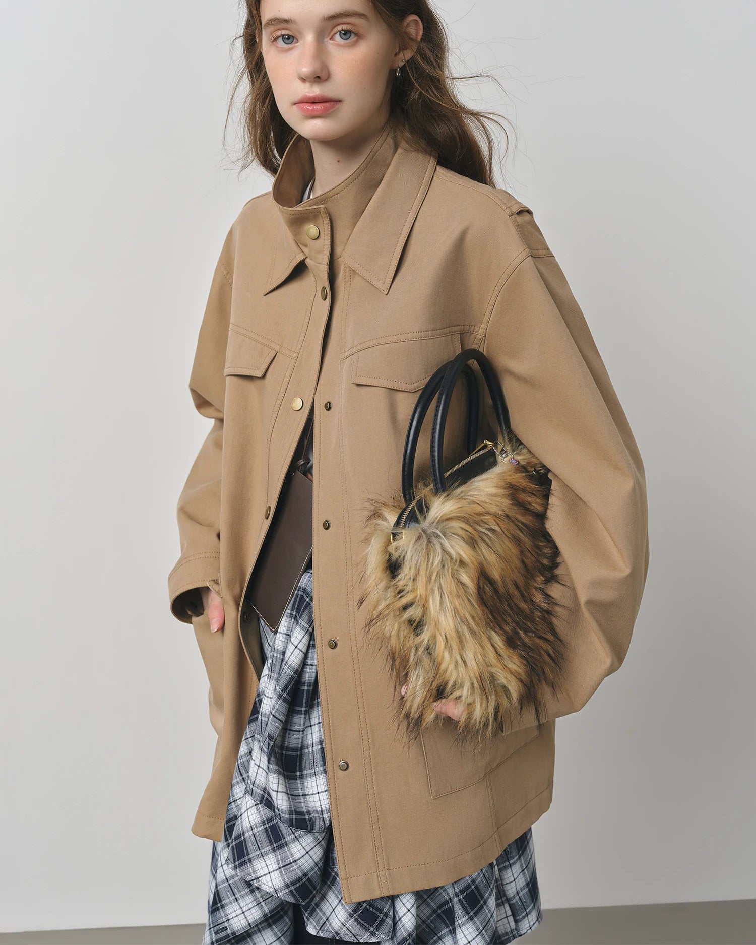 Cotton lyocell solid turtleneck single-breasted loose long knit coat with pockets. Vintage, retro, and relaxed — a chic workwear autumn winter outerwear for women.