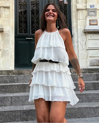 Halter neck mini dress with layered decorative detail, backless design and slim A-line fit. Soft Lanon fabric — sweet and sexy beach style for spring and summer.