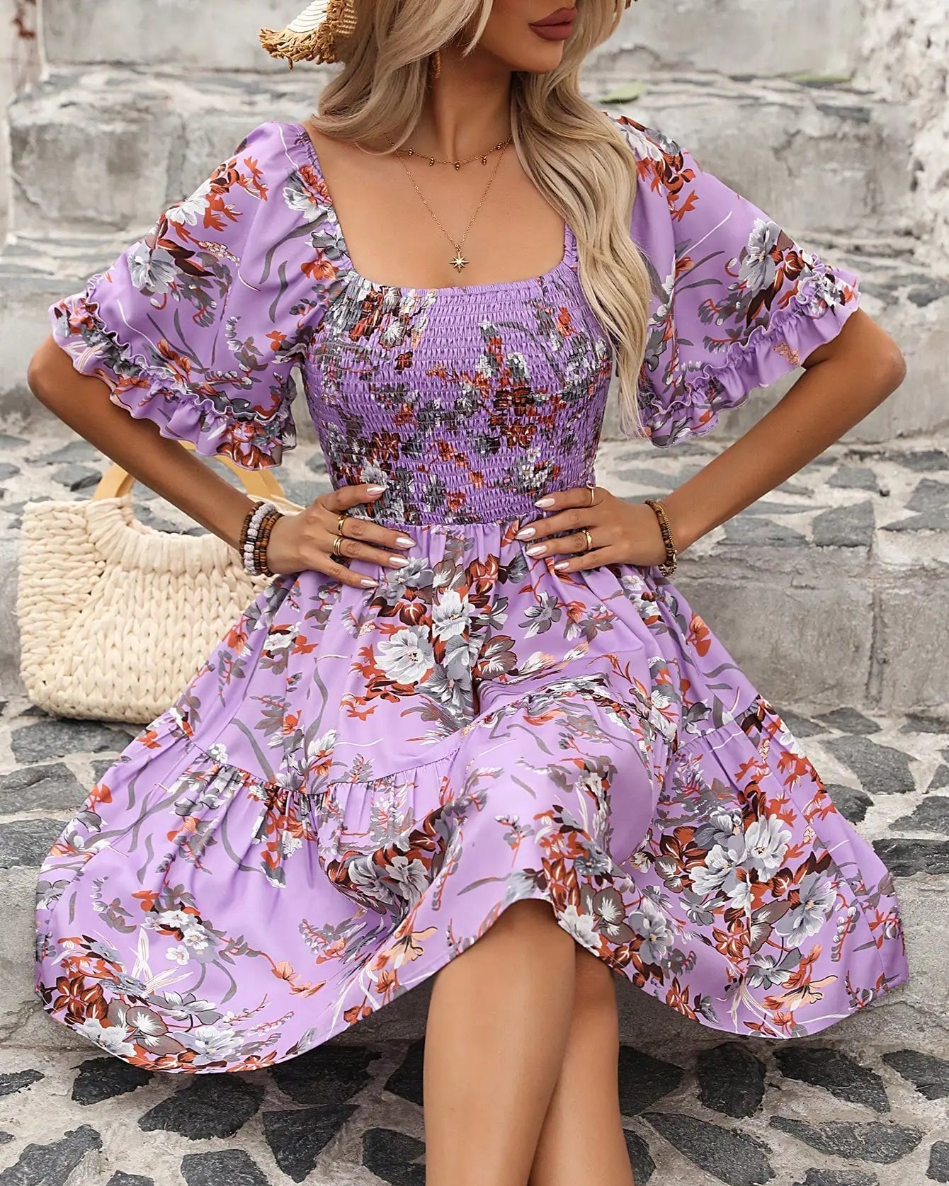 the Floral Smocked Boho Dress. Featuring a tiered ruffle hem, puff sleeves, and an elasticated waist, this feminine mini dress is perfect for casual outings.