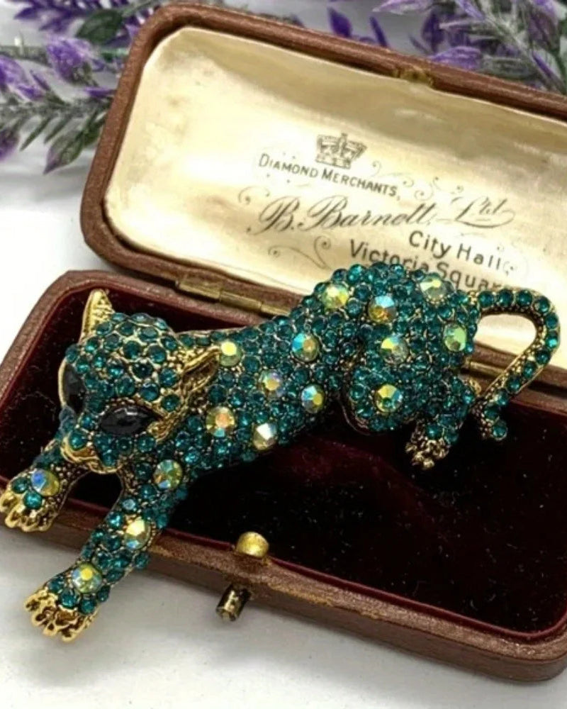 Baroque style leopard print brooch in gold tone, ornate metal pin with bold animal print enamel and vintage detailing, perfect for adding wild elegance.