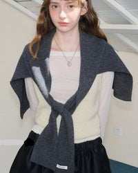 A wool shawl scarf occupies a unique space in cold-weather dressing — it is neither purely a scarf nor purely a shawl, but something more useful than either.