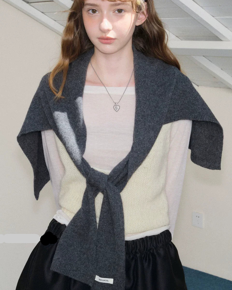 A wool shawl scarf occupies a unique space in cold-weather dressing — it is neither purely a scarf nor purely a shawl, but something more useful than either.